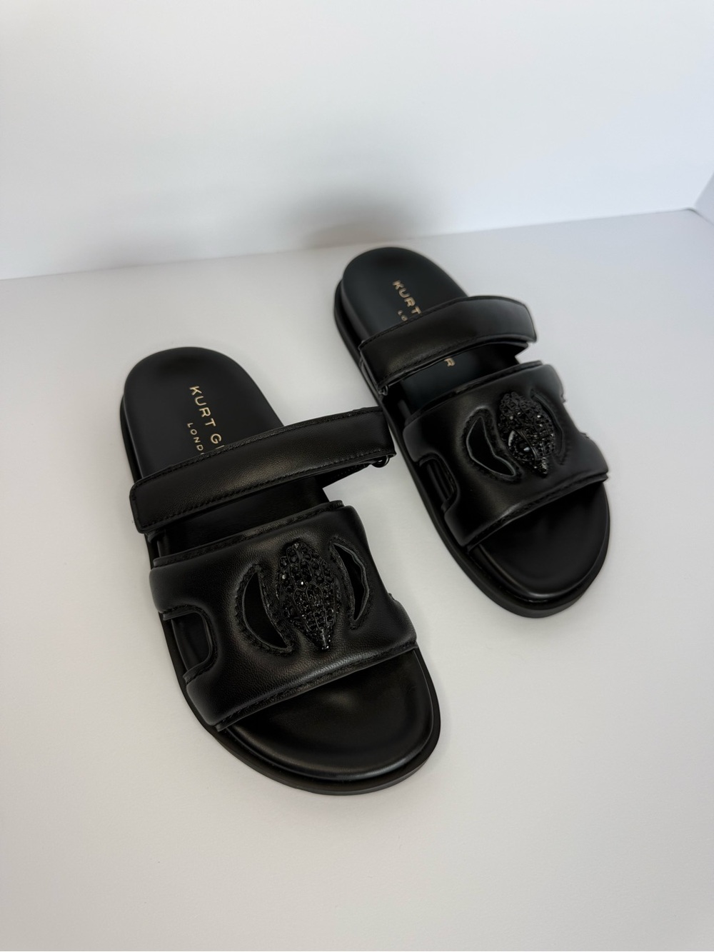 Kurt Geiger Black Leather Slide Sandals with Beaded Crest